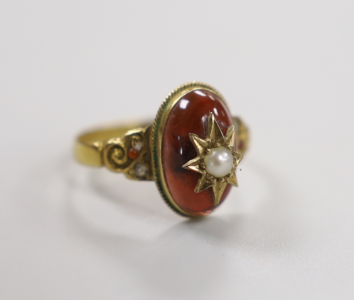 An Edwardian 18ct gold, cabochon garnet, split pearl and gem set ring, size N, gross weight 2.7 grams, with original box.